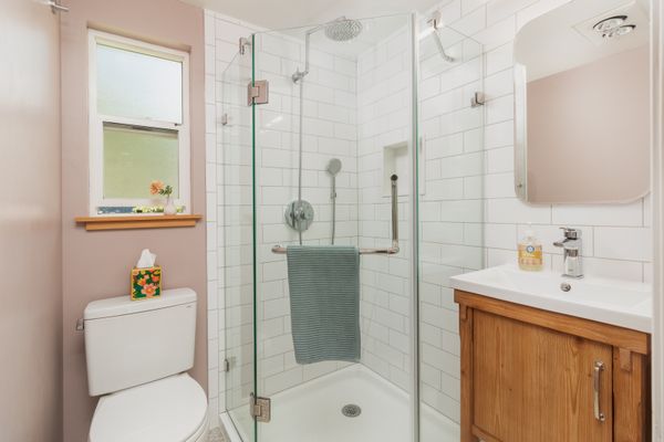 Three-quarter bathroom with glass corner shower