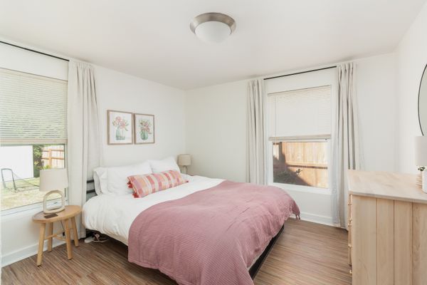 Queen bedroom with pink bedding on the main floor